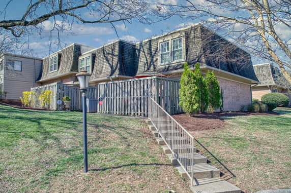 Front view of a two-story house with a shingle roof.