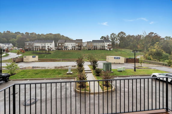 Panoramic view of a residential area with multiple townhouse buildings in the background.