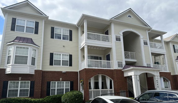 Front view of a multi-story residential building with balconies.
