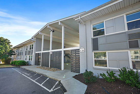 Front view of a multi-story residential building with modern design elements.