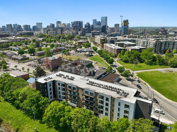 Aerial view of an urban area featuring multiple buildings and green spaces.