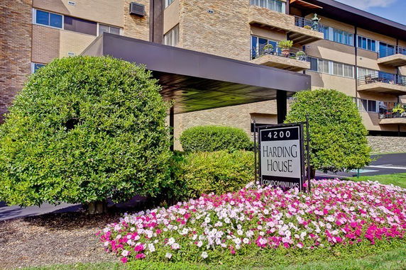 Front view of a multi-story condominium building with balconies.