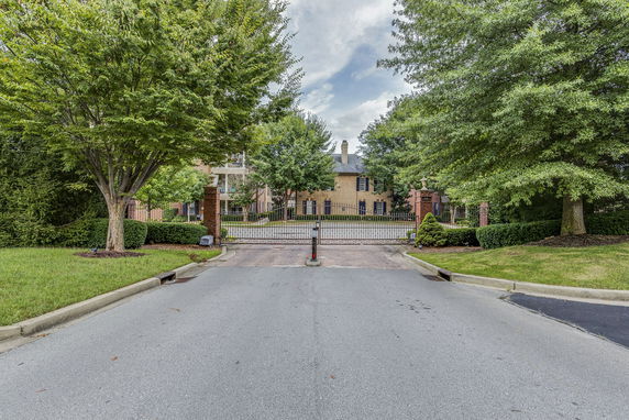Front view of a large estate with a gated entrance.
