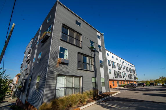 Front view of a modern multi-story building with metal exterior panels.