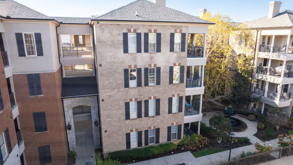 Front view of a multi-story residential building with balconies.