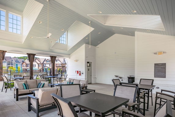 Interior of a clubhouse with seating and high ceilings.