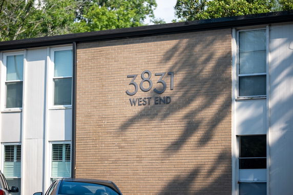 Front view of a brick building with the address '3831 West End' on the wall.