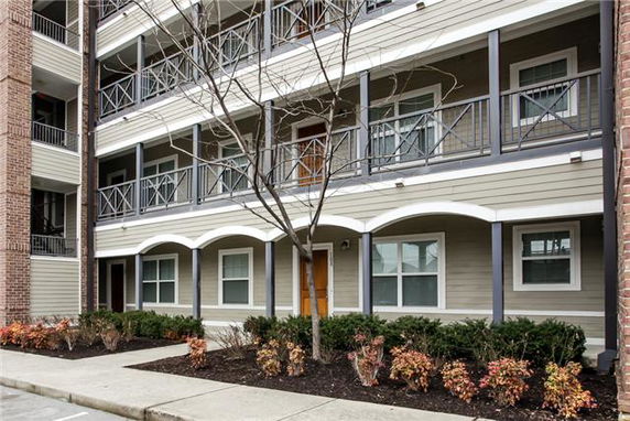 Front view of a multi-story residential building with balconies.