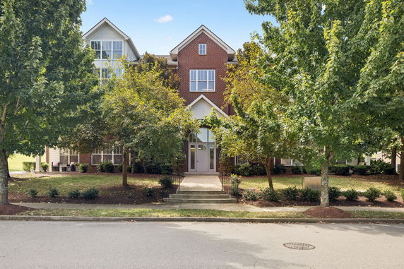 Front view of a multi-story brick building with a central entrance.