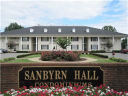 Front view of a two-story condominium building with a gray roof.