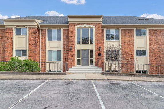 Front view of a two-story building with a central entrance and brick facade.
