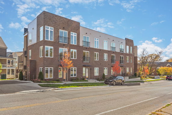 Front view of a three-story brick apartment building.