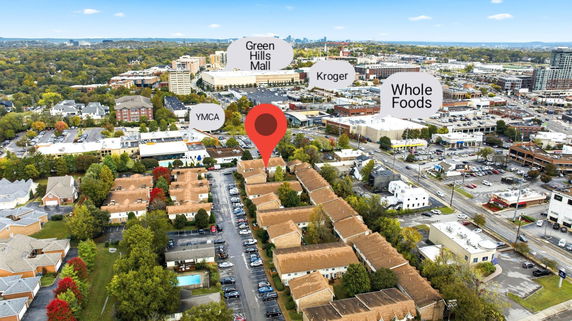 Panoramic view of a city area with various buildings and landmarks like Green Hills Mall and Whole Foods in the distance.