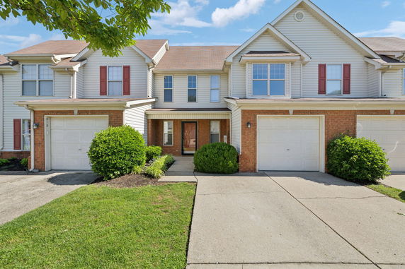 Front view of a two-story townhouse with attached garages.