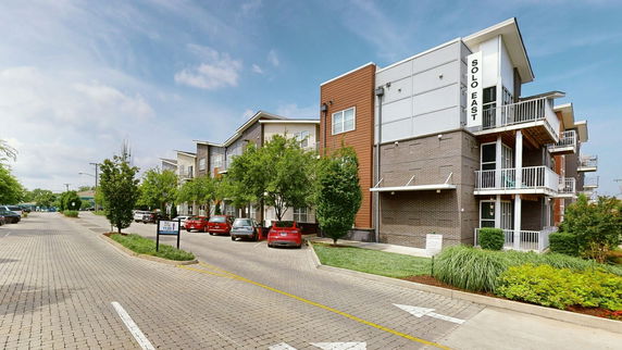 Front view of a multi-story apartment building with balconies.