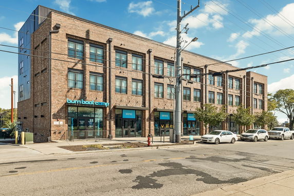 Front view of a three-story commercial brick building.