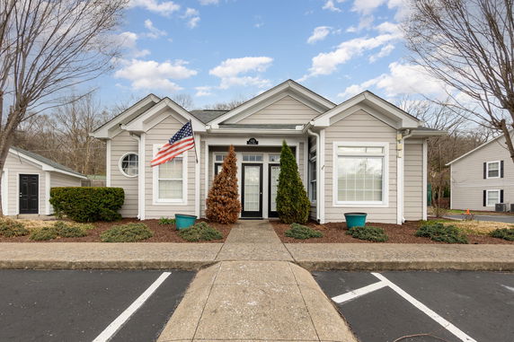 Front view of a single-story house with an American flag.
