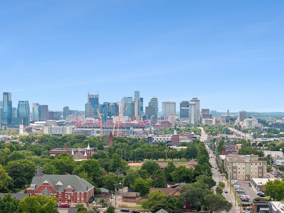 Panoramic view of a city with skyscrapers and residential buildings.
