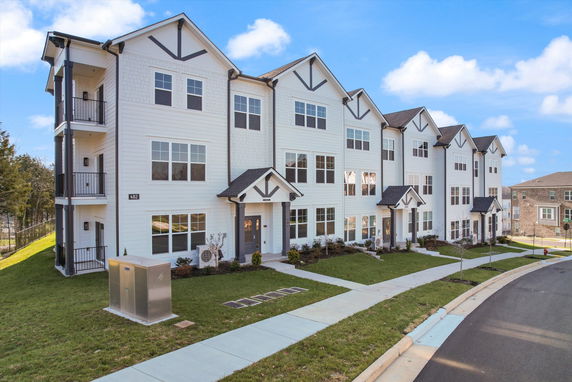 Front view of a multi-story townhouse complex.