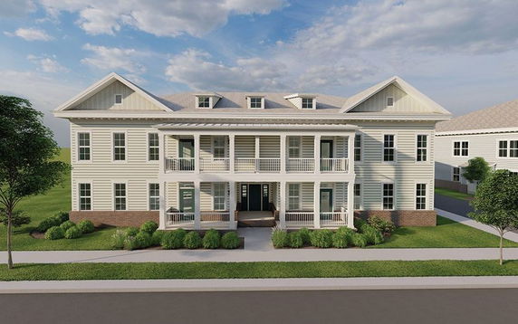 Front view of a two-story building with multiple balconies and white siding.
