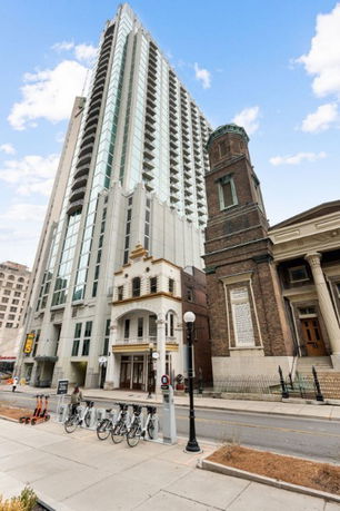 Front view of a tall multi-story building with modern architecture.