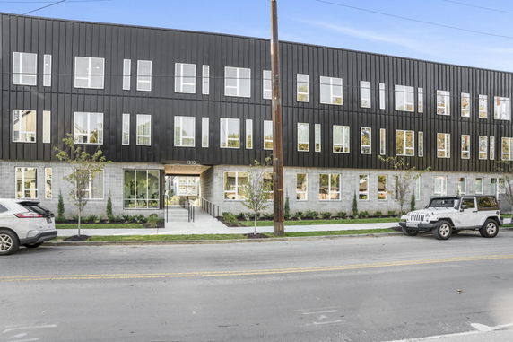 Front view of a three-story building with modern design and large windows.
