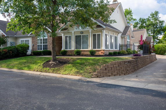 Front view of a single-story house with a brick and siding exterior.