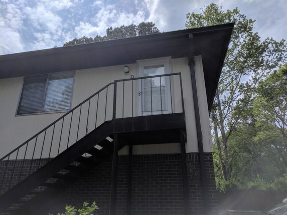 Side view of a house with an external staircase.