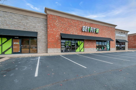 Front view of a commercial building with multiple storefronts.