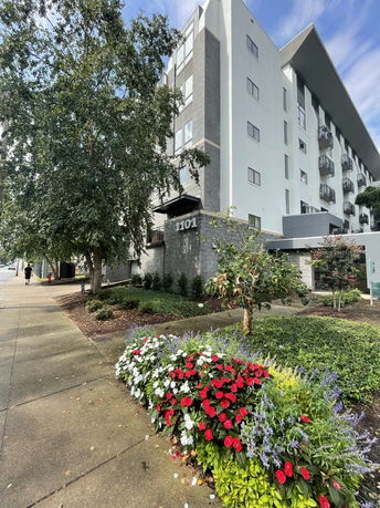 Front view of a multi-story residential building with balconies.