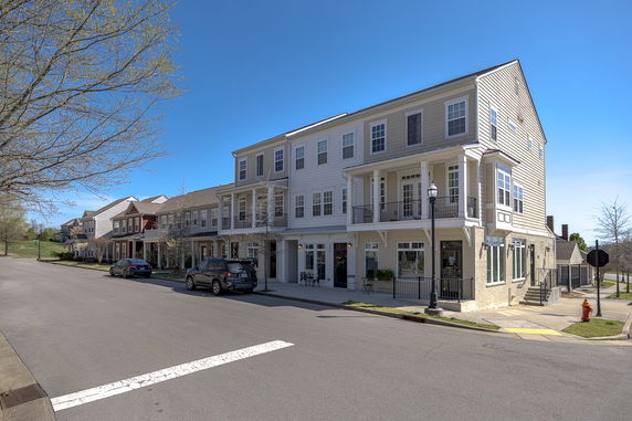 Front view of a multi-story residential building with balconies.