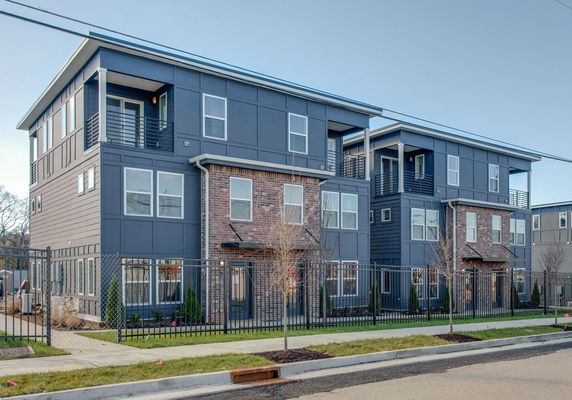 Front view of a multi-story residential building with a modern design.