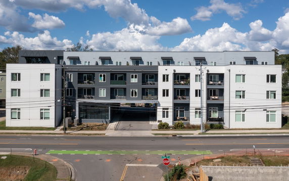 Front view of a multi-story residential building with balconies.