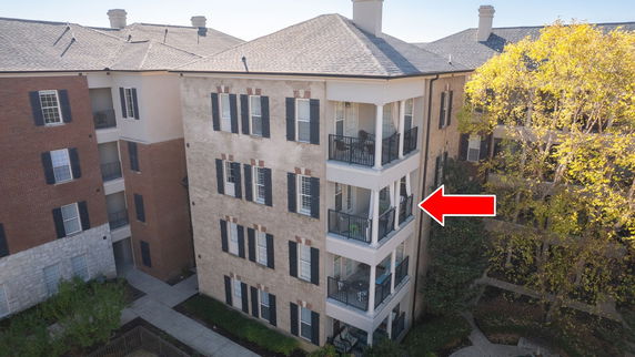 Front view of a multi-story building with balconies.
