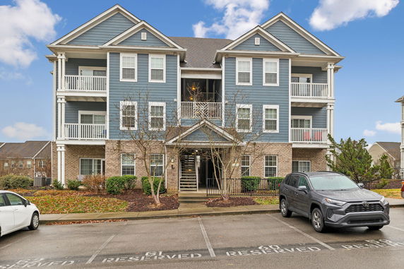 Front view of a three-story residential building with balconies.