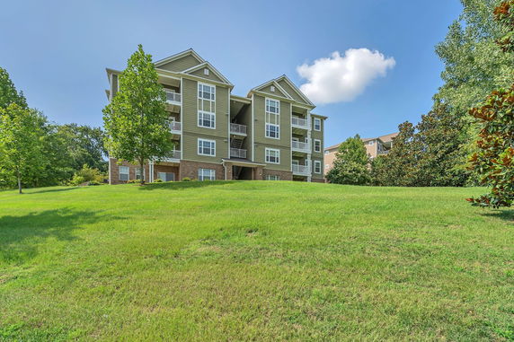 Front view of a multi-story residential building with balconies.