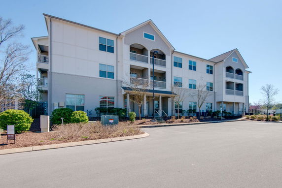 Front view of a three-story apartment building with balconies.