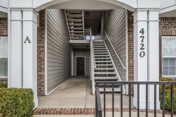 Front entrance of a building with stairs leading upward.