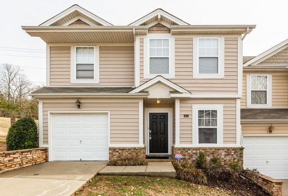 Front view of a two-story house with an attached garage.