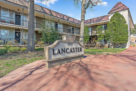 Front view of a two-story building with a central sign displaying the name 'Lancaster'.
