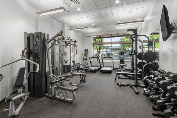 Interior view of a gym with various exercise equipment and machines.