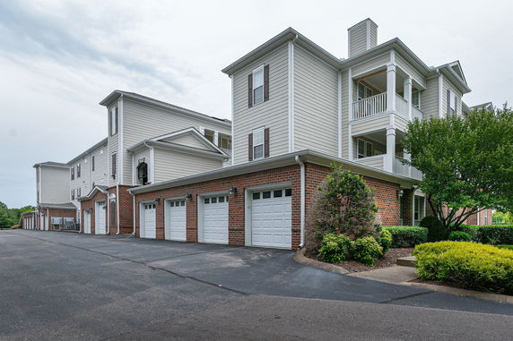 Front view of a multi-story building with attached garages.