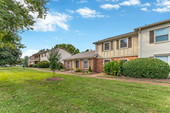 Front view of a two-story residential building with brick and siding exterior.