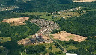 Aerial view of a residential community surrounded by greenery.