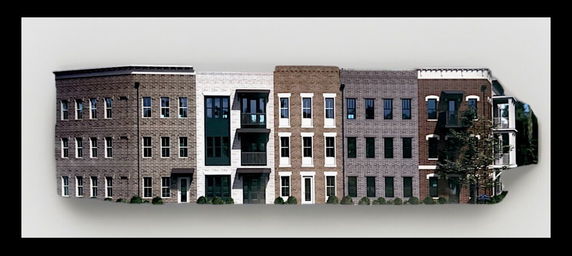Front view of a multi-story building with varied brick facades.