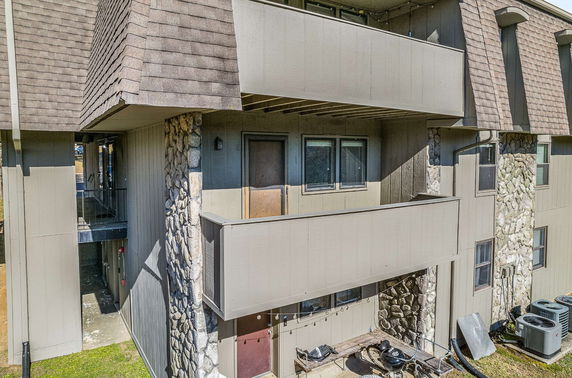 Front view of a multi-story building with balconies and stone accents.