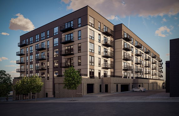 Front view of a modern multi-story apartment building with balconies.