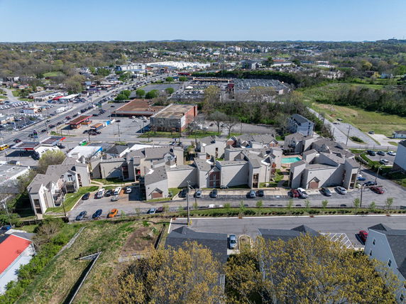 Aerial view of a residential area with apartment buildings and surrounding landscape.