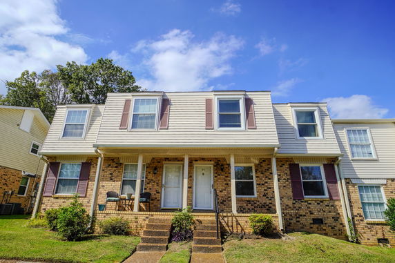 Front view of a two-story brick and siding townhouse.