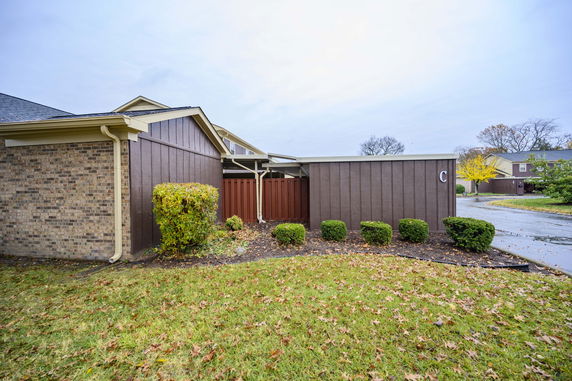 Front view of a house with brick and wood siding.
